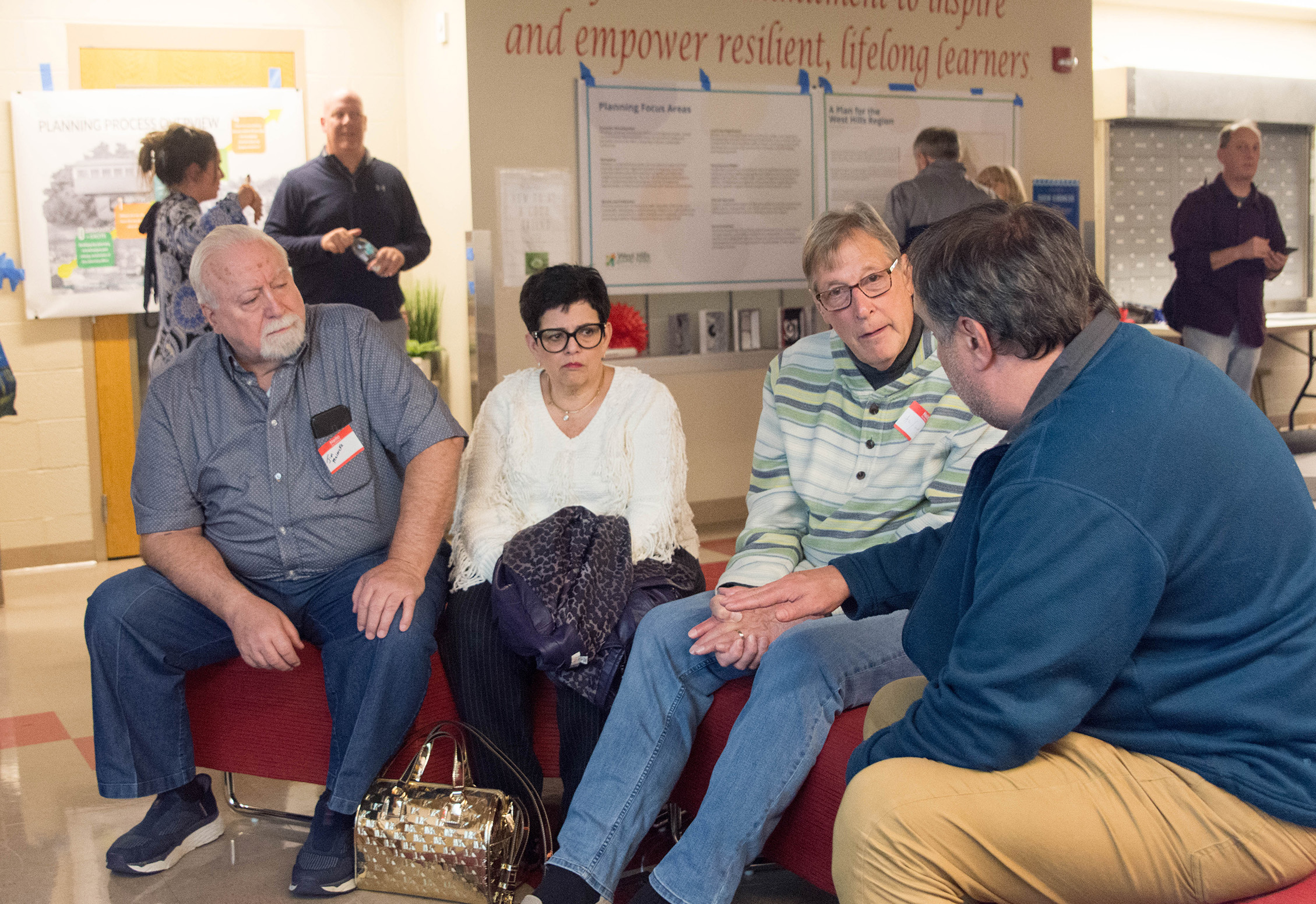 Community members participating in a facilitated small-group conversation