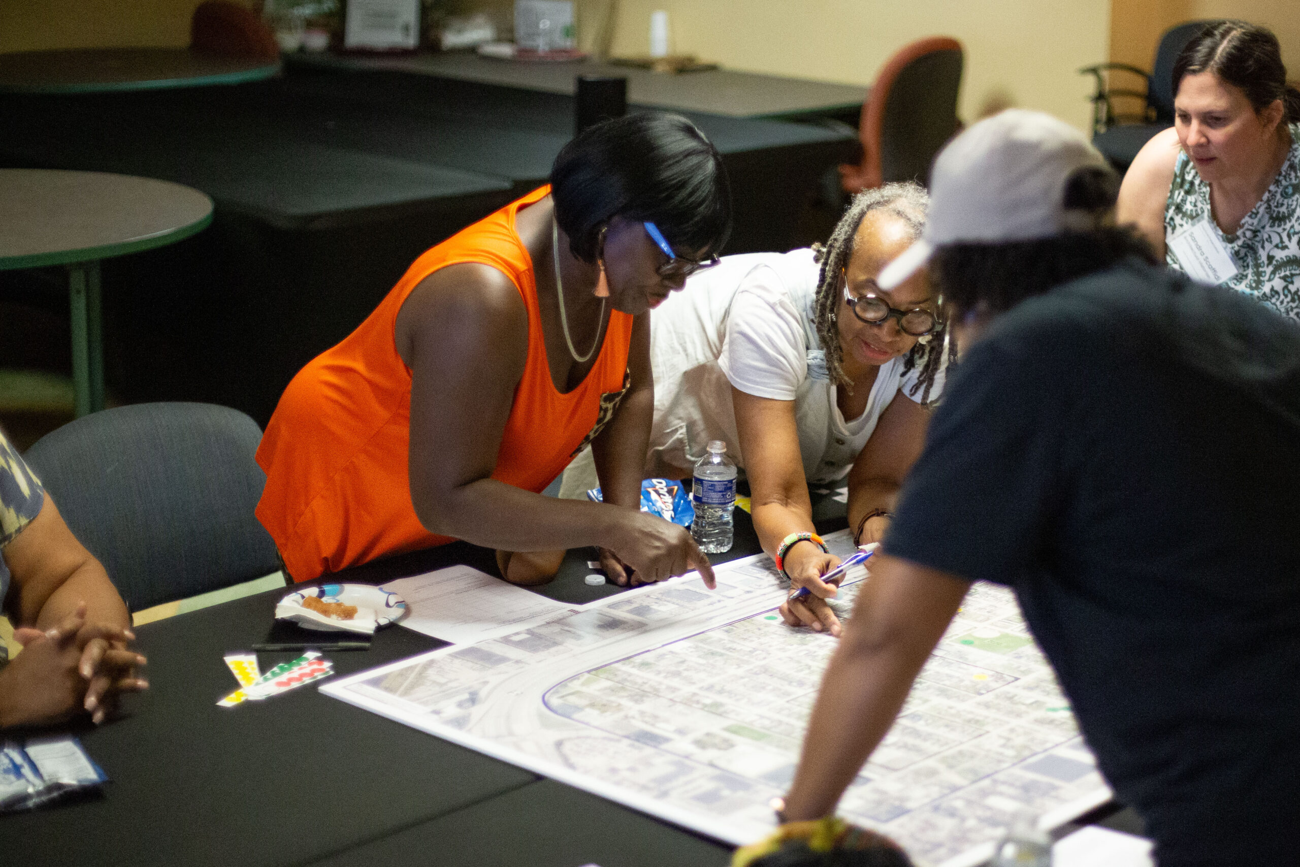 Community members collaborating over a large planning map